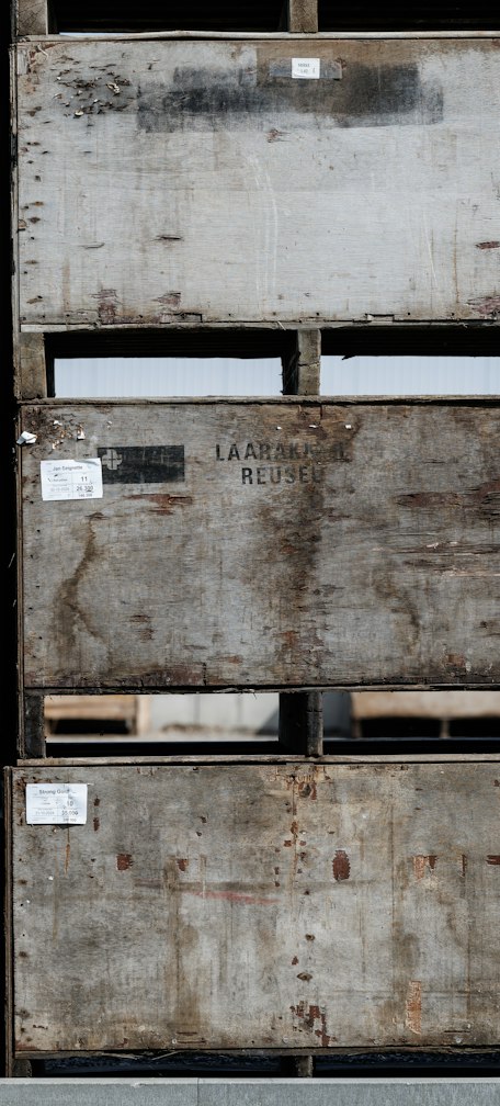 Stacked weathered wooden crates with labels