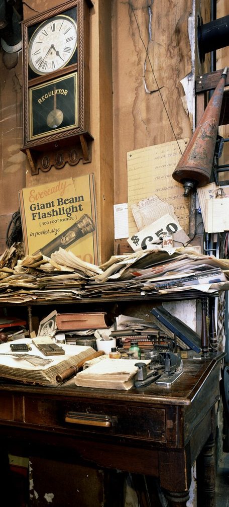 Cluttered desk at the historic Harrison Brothers Hardware in Huntsville, Alabama, whose shelves, resembling an
