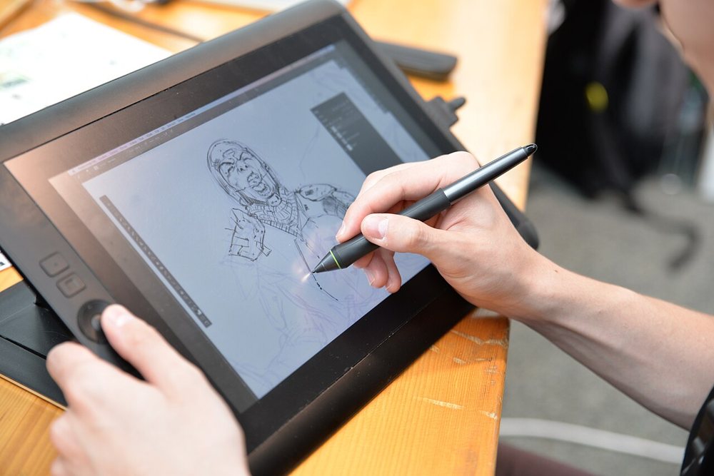 A designer drawing on a pen display: the craft a design agency's showreel sells